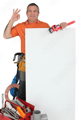 Photo: plumber OK sign behind wall plumber OK sign behind wall