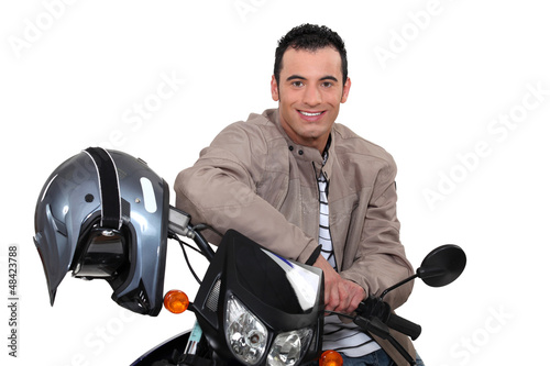 Photo: Smiling man sitting on a motorbike Smiling man sitting on a motorbike
