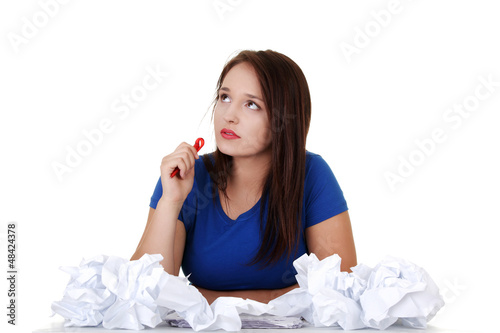 Photo: Young student woman thinking at the desk Young student woman thinking at the desk