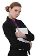 A cute businesswoman holding a folder.