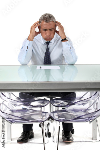 Photo: Businessman stressed over a document Businessman stressed over a document