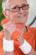 Older woman using dumbbells