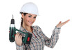 craftswoman holding a drill