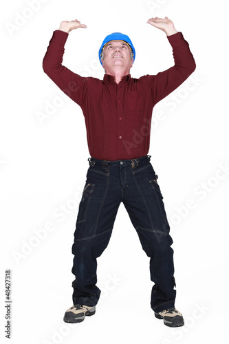 Photo: mature manual worker lifting weight mature manual worker lifting weight