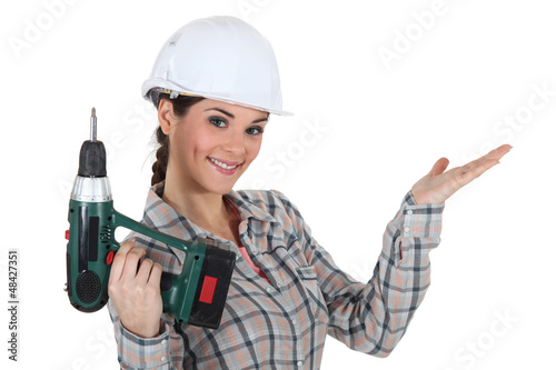 Photo: craftswoman holding a drill craftswoman holding a drill