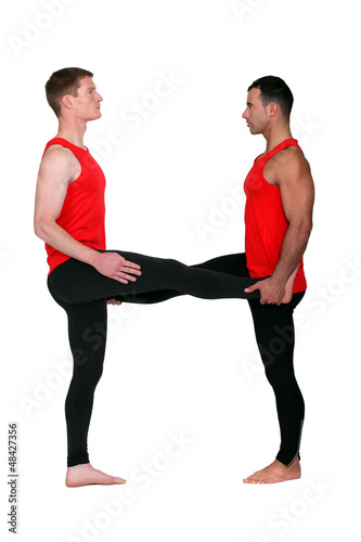 Photo: Two male gymnasts stretching Two male gymnasts stretching