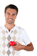 Young man holding red heart