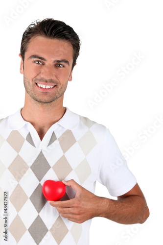 Photo: Young man holding red heart Young man holding red heart