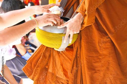 Photo: Gives food offerings to a Buddhist monk Gives food offerings to a Buddhist monk