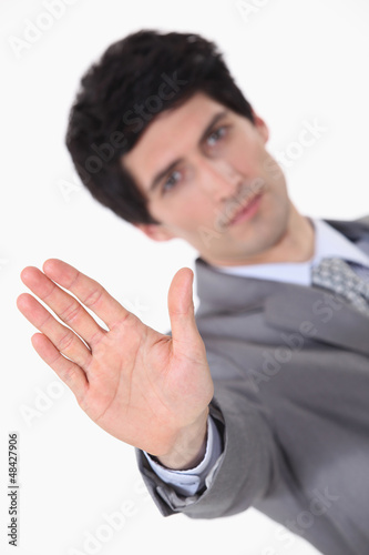 Photo: businessman making a stop sign with his hand businessman making a stop sign with his hand