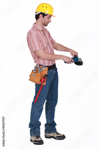 Photo: Manual worker stood with angle grinder Manual worker stood with angle grinder