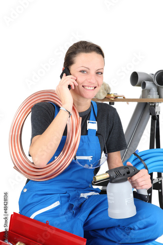 Photo: Female plumber and equipment Female plumber and equipment