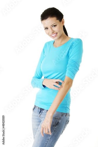 Photo: Young beautiful woman scratching her self. Young beautiful woman scratching her self.