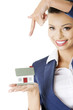 Beautiful businesswoman holding house model
