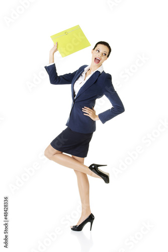Photo: Happy businesswoman holding portfolio Happy businesswoman holding portfolio