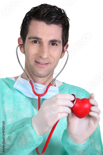 Photo: doctor auscultating plastic heart doctor auscultating plastic heart