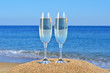 Photo: Glasses of champagne on the beach sand Glasses of champagne on the beach sand