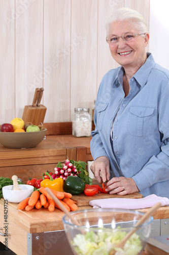 Photo: Old lady chopping vegetables Old lady chopping vegetables