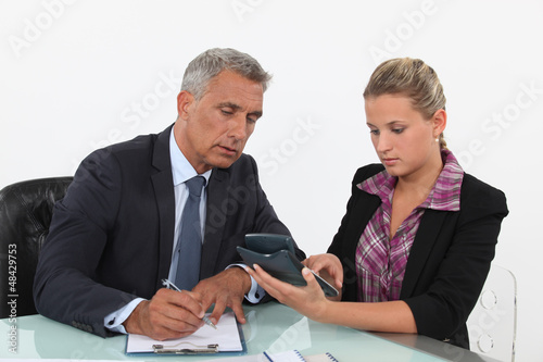 Photo: business partners calculating the budget business partners calculating the budget