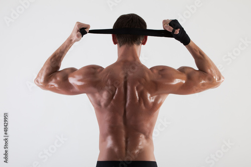 Photo: The muscular male back on white background The muscular male back on white background