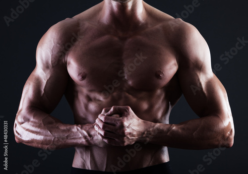 Photo: Muscular male torso with lights showing muscle detail Muscular male torso with lights showing muscle detail