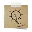 hand draw light bulb on note taped recycle paper