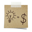Photo: hand draw lightbulb and dollar symbol on note taped recycle pape hand draw lightbulb and dollar symbol on note taped recycle pape