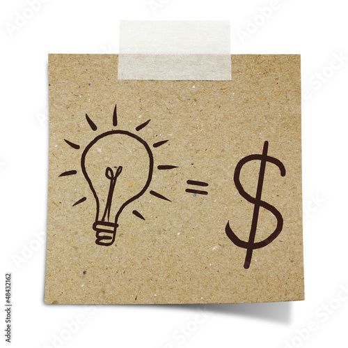 Photo: hand draw lightbulb and dollar symbol on note taped recycle pape hand draw lightbulb and dollar symbol on note taped recycle pape