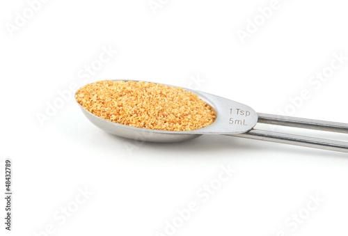 Photo: Garlic granules measured in a metal teaspoon Garlic granules measured in a metal teaspoon