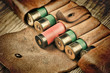 Old hunting cartridges and bandoleer on a wooden table