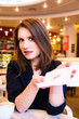 Photo: woman is flirting in modern cafe woman is flirting in modern cafe