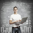 smiling man with laptop