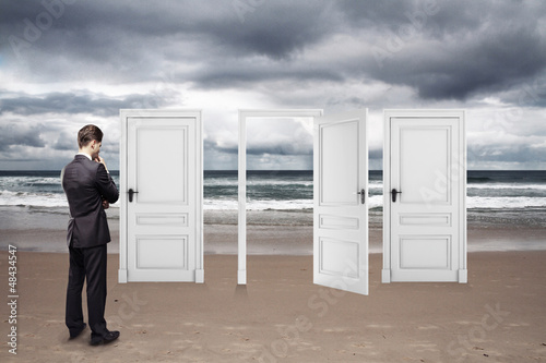 Photo: businessman standing on beach businessman standing on beach