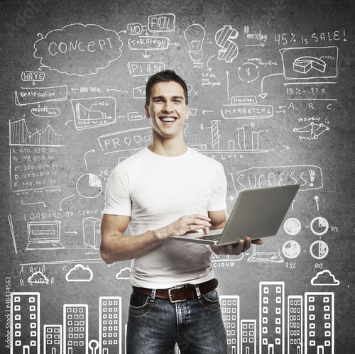 Photo: smiling man with laptop smiling man with laptop