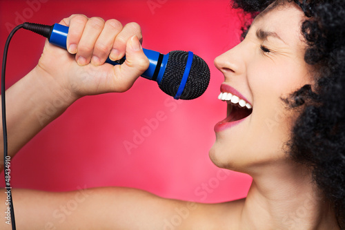 Photo: Woman with afro hairstyle singing Woman with afro hairstyle singing