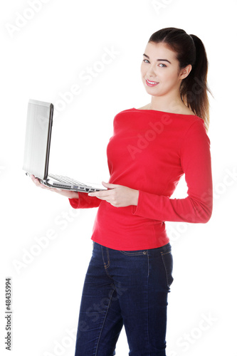 Photo: Young woman working on her laptop computer Young woman working on her laptop computer