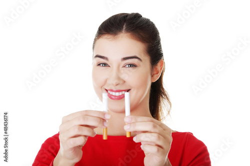 Photo: Woman with cigarette and electronic cigarette Woman with cigarette and electronic cigarette