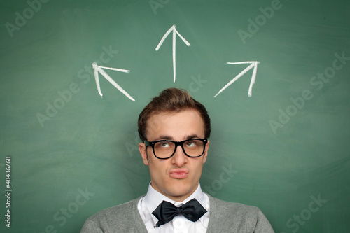 Photo: Man at the Blackboard with Arrows Man at the Blackboard with Arrows