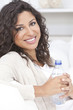 Happy Hispanic Woman Drinking Bottle of Water