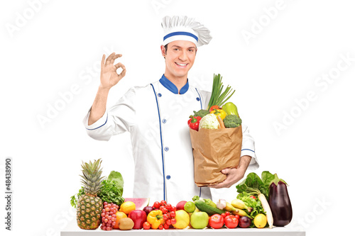 Photo: Male chef holding a bag with healthy ingridients Male chef holding a bag with healthy ingridients