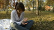 Young woman holding a rowan berries in autumn park