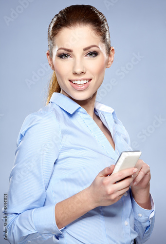 Photo: young woman speaking on phone in studio young woman speaking on phone in studio