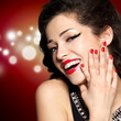Young pretty woman with red manicure and  lips