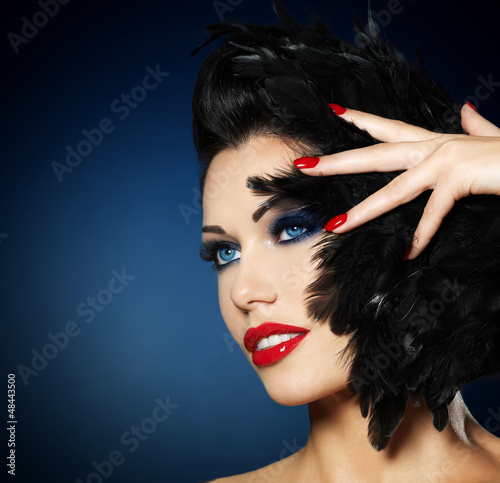 Photo: Woman with red nails and creative hairstyle Woman with red nails and creative hairstyle