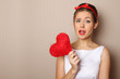 Photo: Beautiful young woman holding a red heart Beautiful young woman holding a red heart