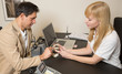 Dental technician showing prosthesis to a customer
