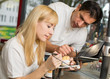 Instructor teaching an apprentice in dental lab