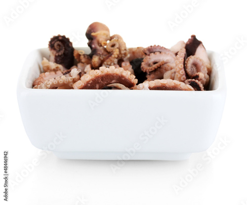 Photo: Tentacles of octopus in bowl isolated on white Tentacles of octopus in bowl isolated on white