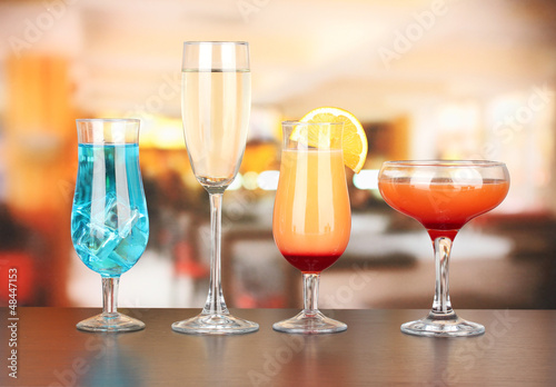 Photo: Several glasses of different drinks on bright background Several glasses of different drinks on bright background