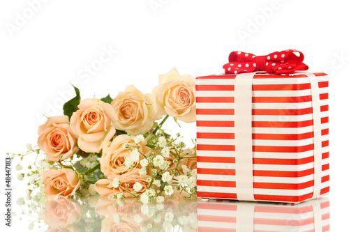 Photo: Giftbox and flowers isolated on white Giftbox and flowers isolated on white